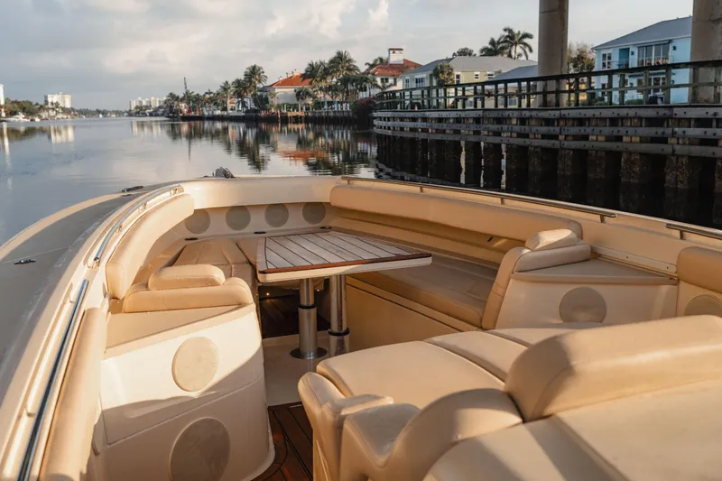  Yacht Photos Pics Luxurious seating area on 2022 HCB 53 Sue&ntilde;os boat, docked by waterfront homes.