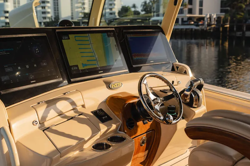  Yacht Photos Pics Helm of 2022 HCB 53 Sue&ntilde;os boat with modern navigation screens and steering wheel.