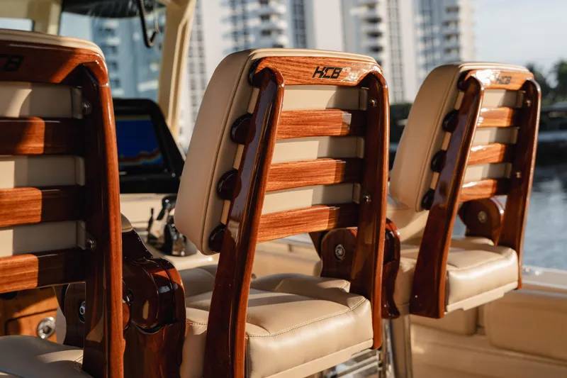  Yacht Photos Pics Luxury seating on 2022 HCB 53 Sue&ntilde;os boat with wooden accents.