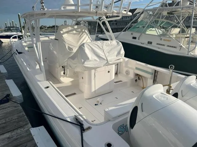  Yacht Photos Pics 2018 Intrepid 375 Walkaround boat docked at marina, covered seating area, twin outboard engines.