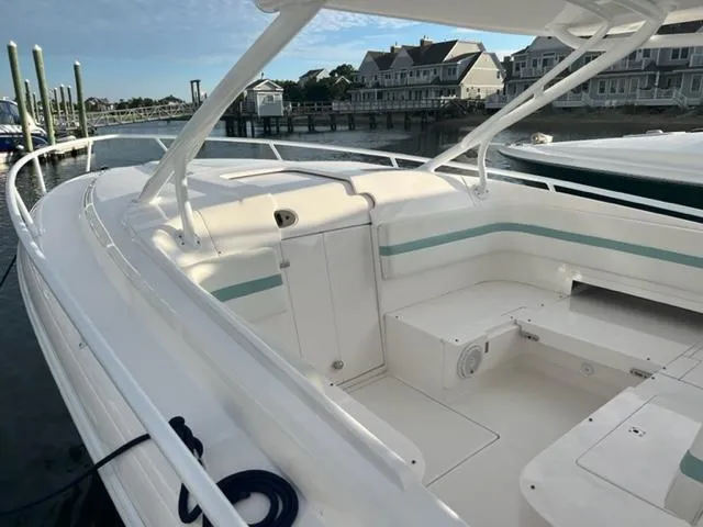  Yacht Photos Pics 2018 Intrepid 375 Walkaround boat docked at a marina with waterfront homes in the background.
