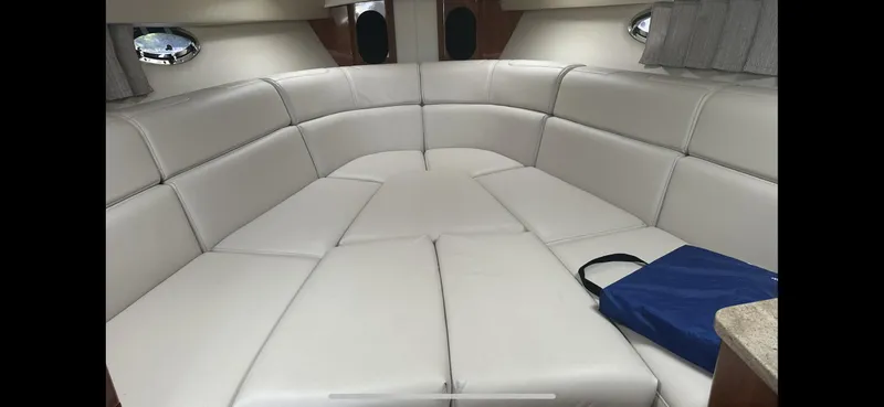  Yacht Photos Pics 2018 Formula 370 Super Sport interior with white leather seating and a blue bag.