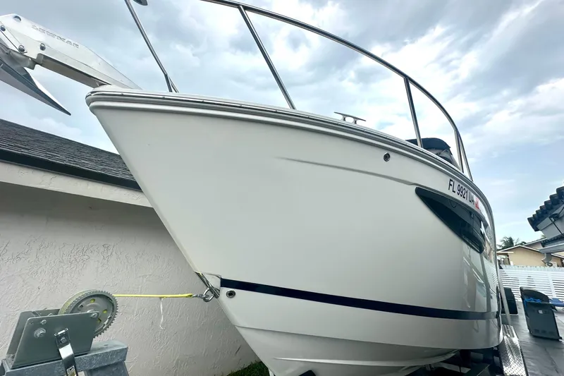  Yacht Photos Pics 2025 Regal 26 XO boat on trailer, side view under cloudy sky.