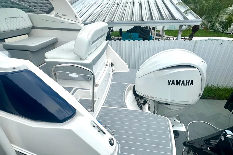  Yacht Photos Pics 2025 Regal 26 XO boat with Yamaha outboard engine, featuring sleek seating and modern design.