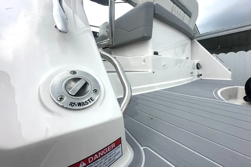  Yacht Photos Pics 2025 Regal 26 XO boat deck with waste disposal port and seating area.