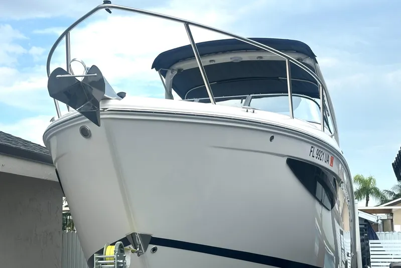  Yacht Photos Pics 2025 Regal 26 XO boat with sleek design, docked under a clear sky.