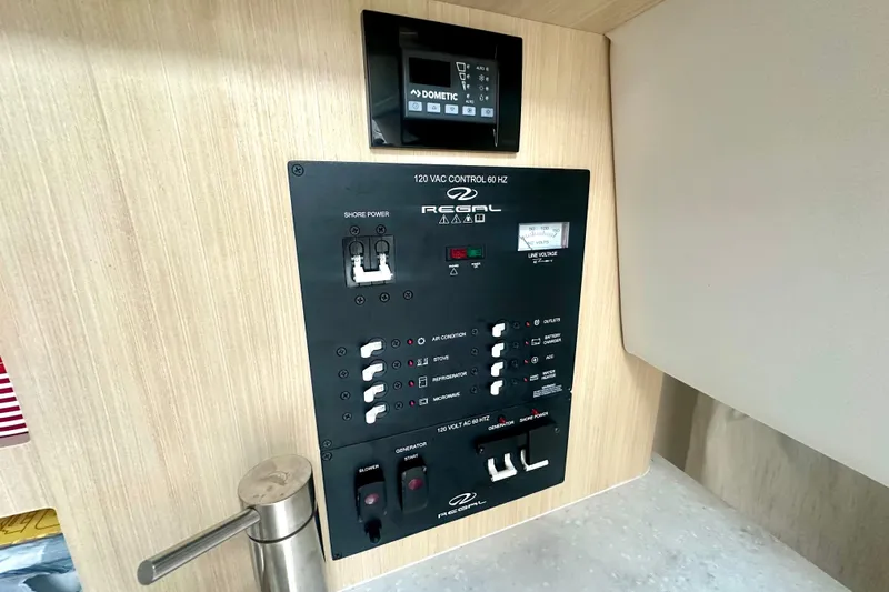  Yacht Photos Pics Control panel of 2025 Regal 26 XO boat, featuring switches and voltage display.