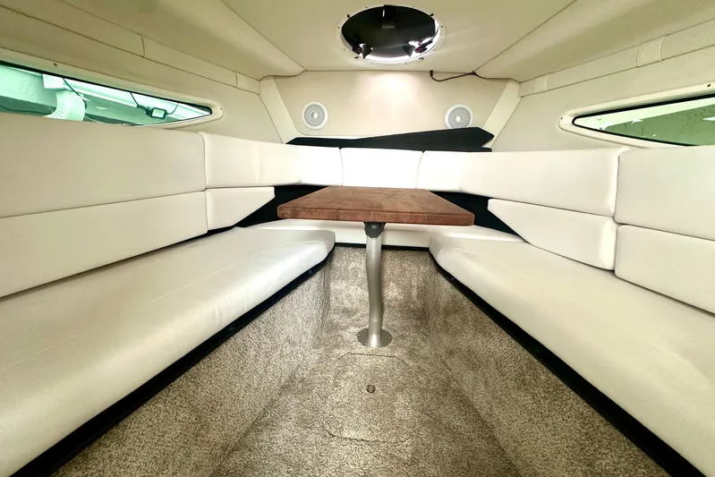  Yacht Photos Pics Interior of 2025 Regal 26 XO boat with plush seating and wooden table.