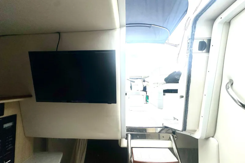  Yacht Photos Pics Interior view of 2025 Regal 26 XO boat with TV and open cabin door.
