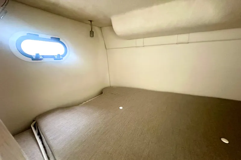  Yacht Photos Pics 2025 Regal 26 XO cabin interior with bed and porthole window.