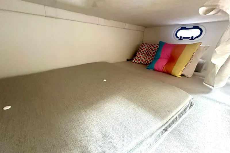  Yacht Photos Pics Cozy cabin interior of 2025 Regal 26 XO boat with colorful pillows and window.