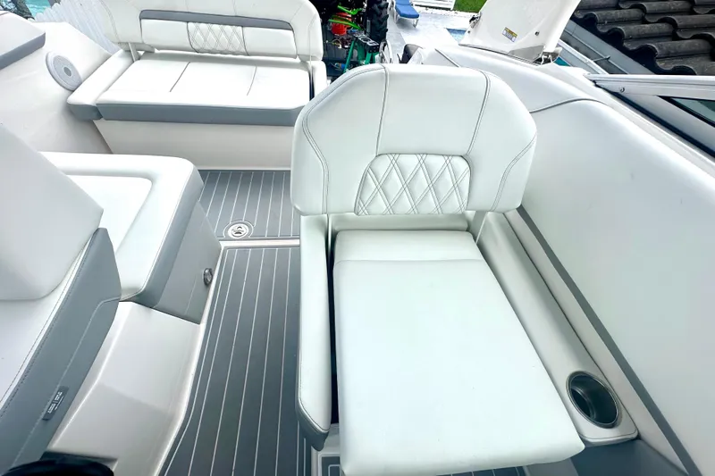  Yacht Photos Pics 2025 Regal 26 XO boat interior with white cushioned seating and sleek flooring.