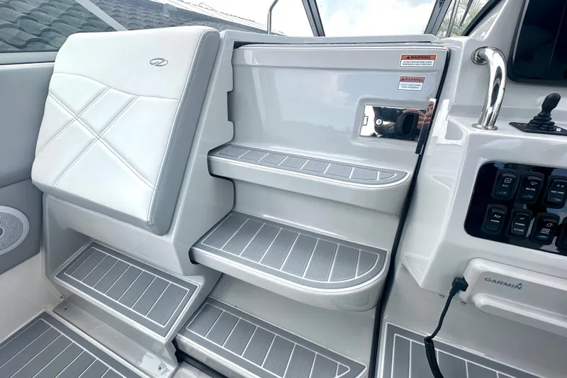  Yacht Photos Pics Interior of 2025 Regal 26 XO boat, featuring sleek seating and control panel.