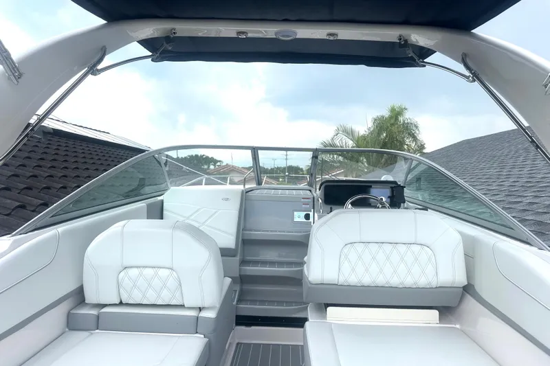  Yacht Photos Pics 2025 Regal 26 XO boat interior with white seating and modern dashboard.