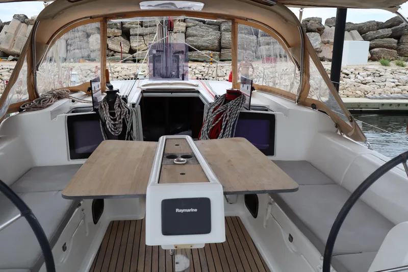  Yacht Photos Pics Spacious cockpit of 2016 Dufour 382 Grand Large sailboat with wooden table and seating.