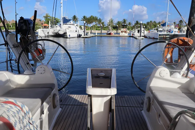 Yacht Photos Pics Dufour 382 Grand Large 2016 sailboat docked in a sunny marina with palm trees.