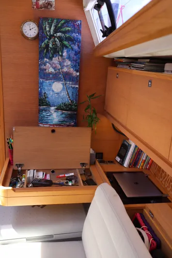  Yacht Photos Pics Interior of 2016 Dufour 382 Grand Large yacht with desk, books, and tropical artwork.