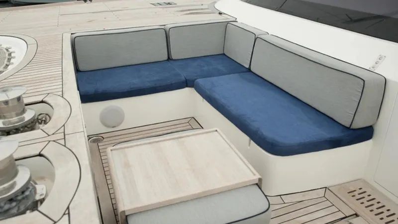 Kailua Yacht Photos Pics Luxury Sunreef 74C 2018 yacht deck with cushioned seating and wooden table.