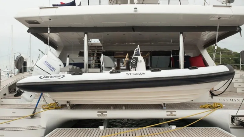 Kailua Yacht Photos Pics 2018 Sunreef 74C yacht with a small boat on the deck, docked at a marina.