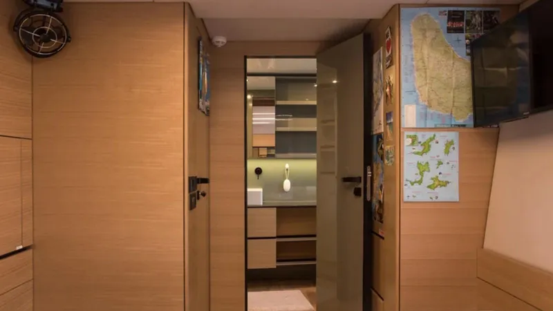 Kailua Yacht Photos Pics Interior of 2018 Sunreef 74C yacht with wooden panels and nautical maps.