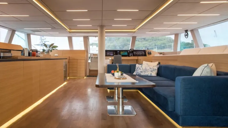 Kailua Yacht Photos Pics Luxurious interior of 2018 Sunreef 74C yacht with modern furnishings and panoramic windows.