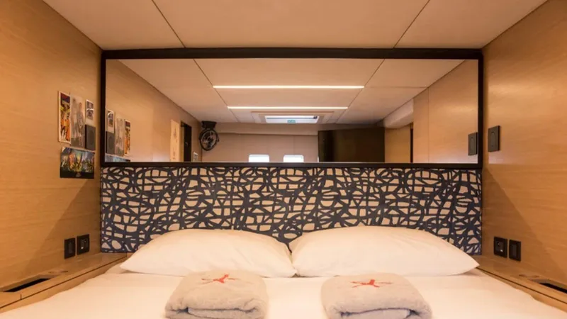 Kailua Yacht Photos Pics Luxurious Sunreef 74C 2018 yacht bedroom with modern decor and plush bedding.
