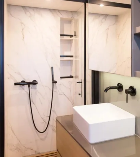 Kailua Yacht Photos Pics Luxurious bathroom in 2018 Sunreef 74C yacht with modern fixtures and marble walls.