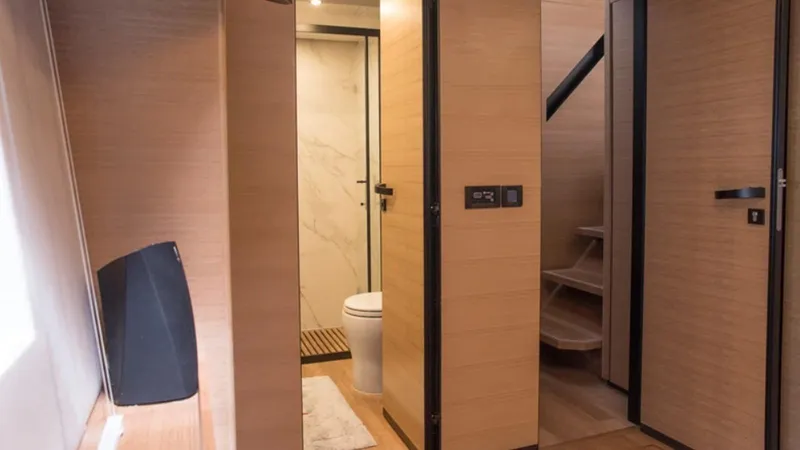 Kailua Yacht Photos Pics Luxurious interior of 2018 Sunreef 74C yacht featuring modern bathroom and wooden finishes.