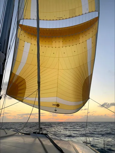  Yacht Photos Pics Yellow sail of Fountaine Pajot Saona 47 at sunset, 2018.