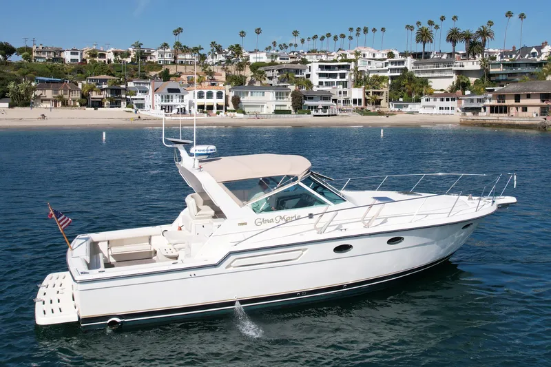 Gina Marie Yacht Photos Pics 1997 Tiara Yachts 3700 Open cruising near a scenic coastal neighborhood.