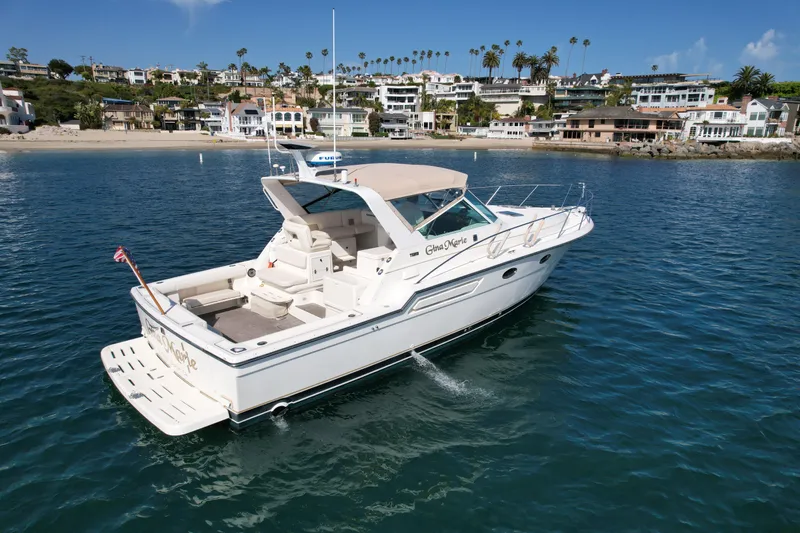 Gina Marie Yacht Photos Pics 1997 Tiara Yachts 3700 Open cruising near a scenic coastal town.