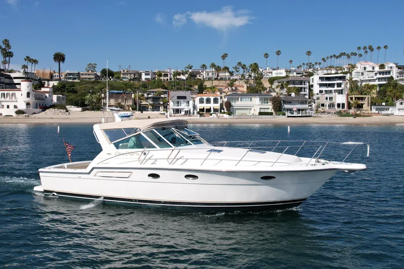 Gina Marie Yacht Photos Pics 1997 Tiara Yachts 3700 Open cruising near a scenic coastal neighborhood.
