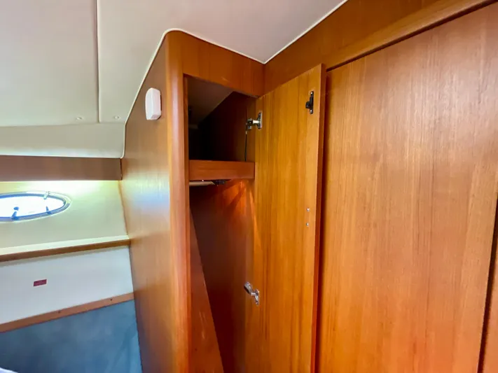 Gina Marie Yacht Photos Pics 1997 Tiara Yachts 3700 Open interior with wooden cabinetry and porthole window.