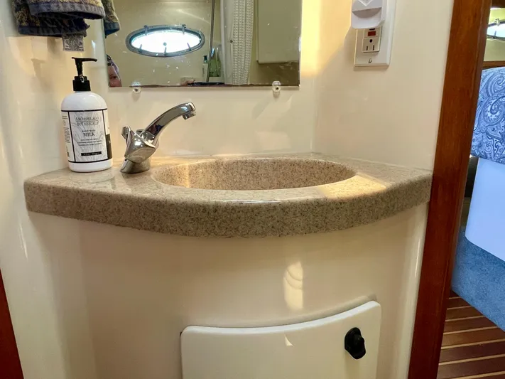 Gina Marie Yacht Photos Pics Bathroom sink area in a 1997 Tiara Yachts 3700 Open, featuring a modern faucet.