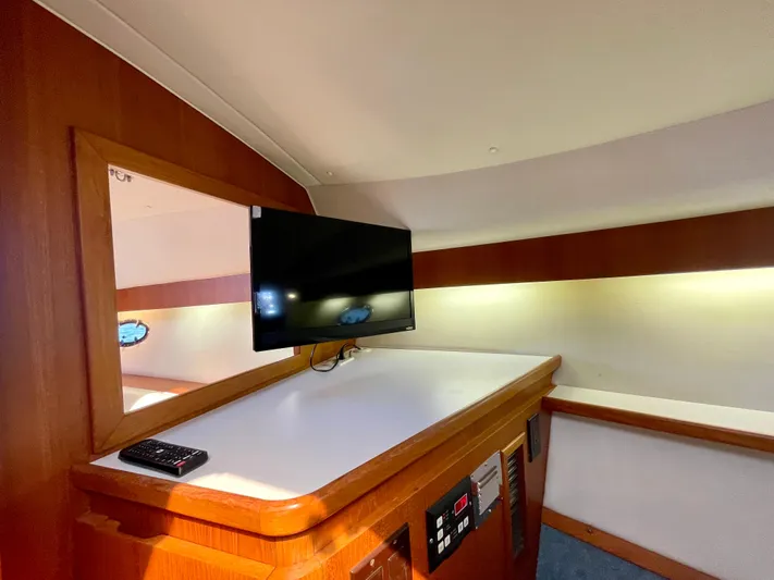 Gina Marie Yacht Photos Pics 1997 Tiara Yachts 3700 Open interior with mounted TV and control panel.