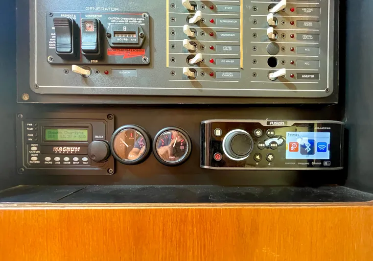 Gina Marie Yacht Photos Pics Control panel of a 1997 Tiara Yachts 3700 Open, featuring gauges and electronic systems.