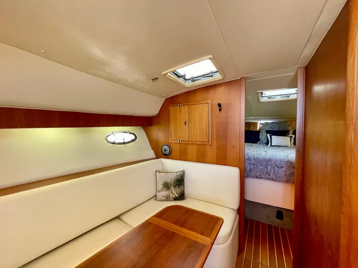 Gina Marie Yacht Photos Pics 1997 Tiara Yachts 3700 Open interior with cozy seating and wooden accents.