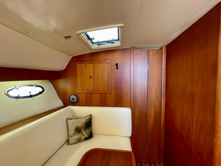 Gina Marie Yacht Photos Pics Interior of 1997 Tiara Yachts 3700 Open with wood paneling and white seating.