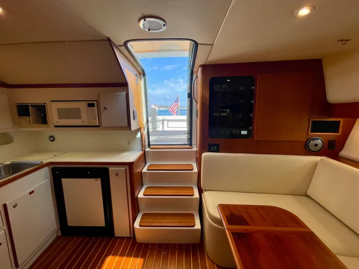Gina Marie Yacht Photos Pics Interior of 1997 Tiara Yachts 3700 Open, featuring kitchen and seating area.