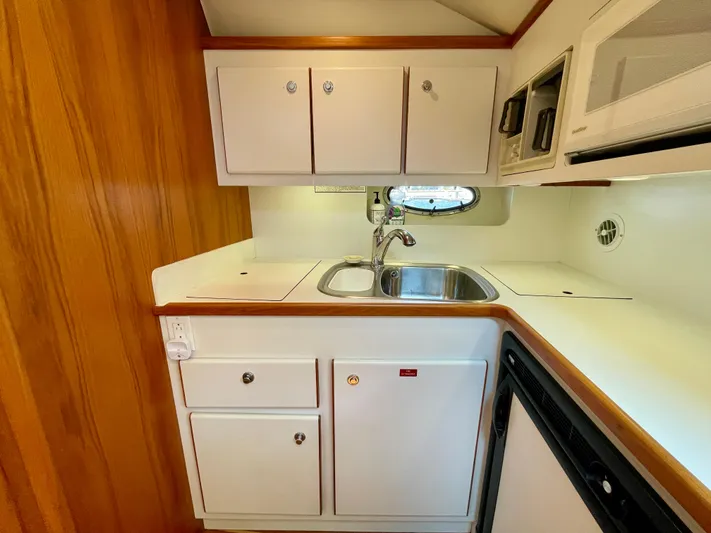 Gina Marie Yacht Photos Pics 1997 Tiara Yachts 3700 Open galley with sink, cabinets, and microwave.