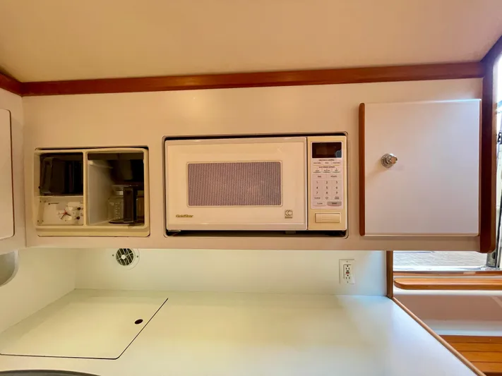 Gina Marie Yacht Photos Pics 1997 Tiara Yachts 3700 Open galley with microwave and storage cabinets.