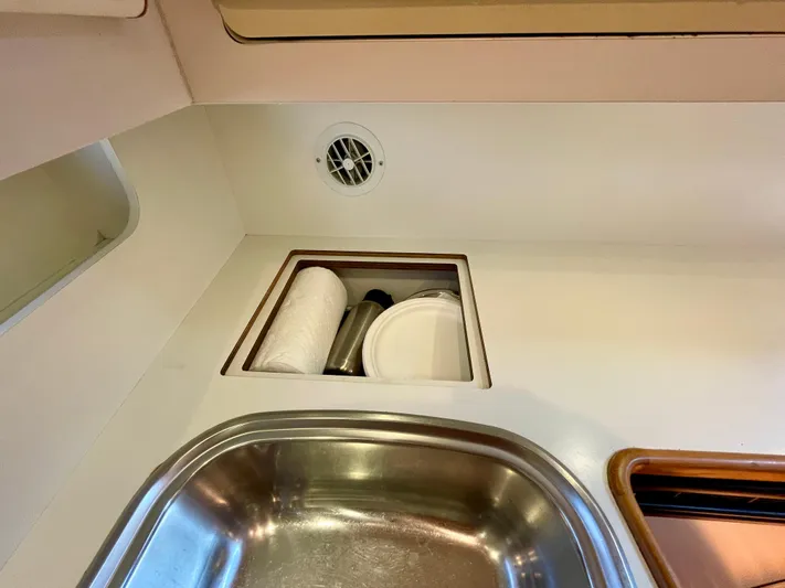 Gina Marie Yacht Photos Pics 1997 Tiara Yachts 3700 Open interior with sink and storage compartment.