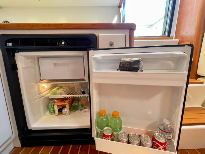 Gina Marie Yacht Photos Pics Mini fridge stocked with drinks inside a 1997 Tiara Yachts 3700 Open.