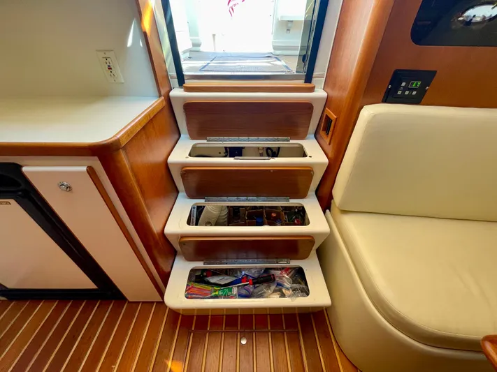 Gina Marie Yacht Photos Pics 1997 Tiara Yachts 3700 Open interior with wooden steps and storage compartments.