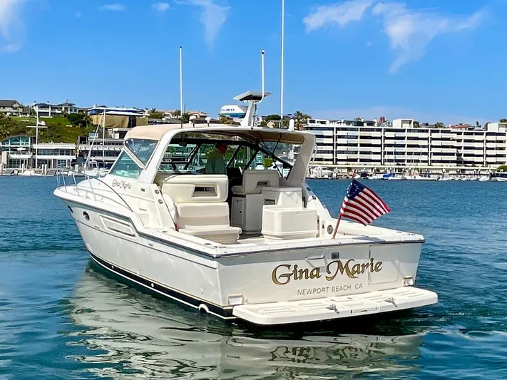 Gina Marie Yacht Photos Pics 1997 Tiara Yachts 3700 Open boat in marina, Newport Beach, with American flag.