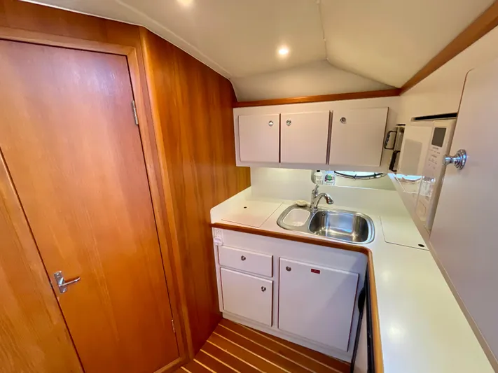 Gina Marie Yacht Photos Pics 1997 Tiara Yachts 3700 Open galley with wood cabinetry and modern amenities.