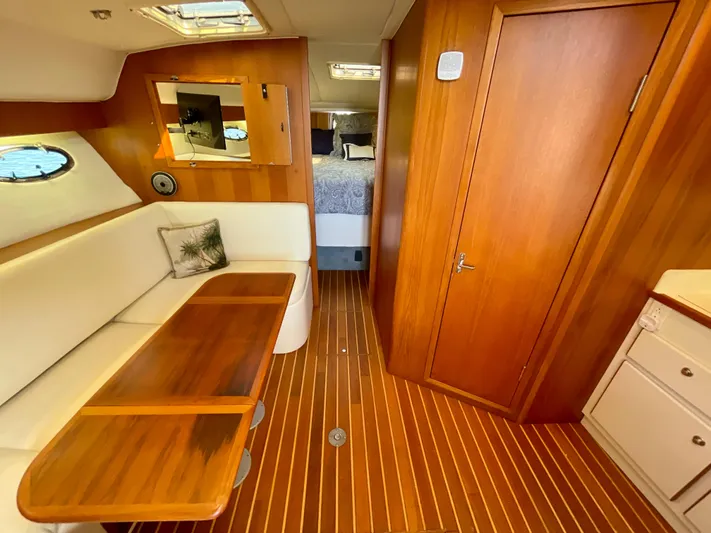 Gina Marie Yacht Photos Pics 1997 Tiara Yachts 3700 Open interior with wood finish, seating, and table.