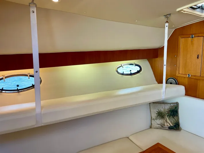 Gina Marie Yacht Photos Pics 1997 Tiara Yachts 3700 Open interior with portholes, wooden accents, and cushioned seating.