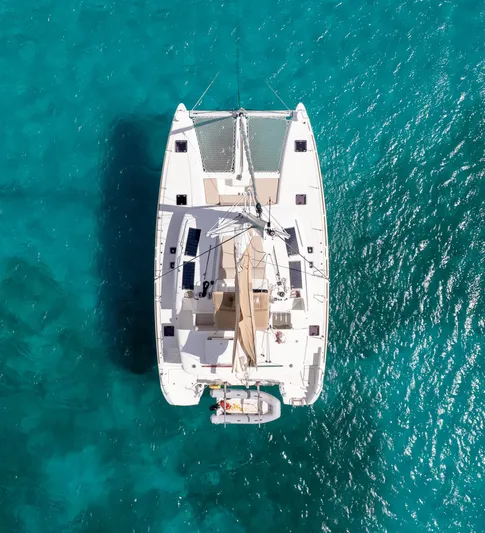 Altair Yacht Photos Pics Aerial view of 2018 Lagoon 450 F catamaran on clear turquoise water.