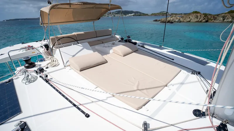 Altair Yacht Photos Pics 2018 Lagoon 450 F catamaran with sunbathing area, anchored in clear turquoise waters.